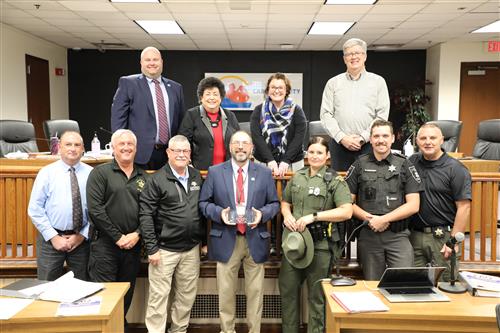 Kim Cooper & work family picture with board members