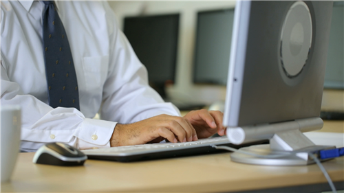 Stock Image - Man working on computer